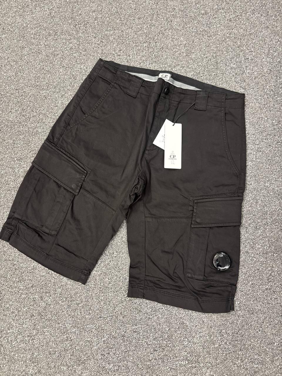 C.P COMPANY 116A SATIN STRETCH CARGO SHORTS IN BLACK - Image 1