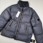 CP COMPANY 265A LENS BI-TM DOWN JACKET IN BLUE 995
