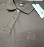 C.P COMPANY STRETCH PIQUET POLO SHIRT IN BROWN - Image 7
