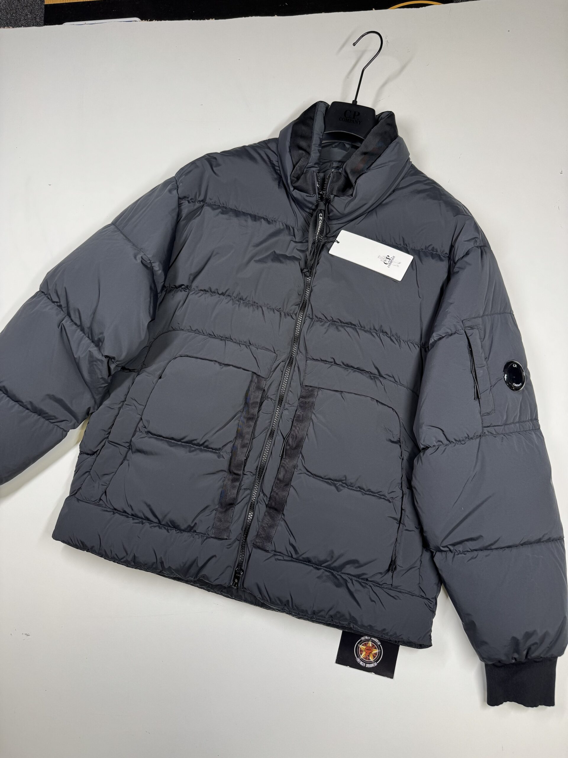 img_8685 CP COMPANY NYCRA-R DOWN JACKET IN SMOKE GREY - Image 1