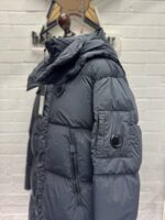 CP COMPANY 202A LENS BUTTON NYCRA-R LONG JACKET IN BLACK SAND  - Large / 25” P2P - Image 2