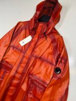 CP COMPANY 129A BI-FILM PARKA LENS JACKET IN PUMPKIN ORANGE - Image 4