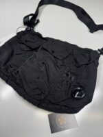 CP Company Chrome-R Tote Backpack in Green 

Rrp £255 

Large and versatile bag from C.P. Company in their nylon based Chrome-R material with tote straps and adjustable padded straps. The tote bag/backpack also features a large zipped main compartment with an inner zip sleeve, zipped front pocket, two side pouches with drawcord closure and a tonal C.P. Company logo embroidered on the front. 

100% Nylon
Water Resistant
Tote Handles
Padded Adjustable Shoulder Straps
Large Main Zip Compartment
Inner Zipped Sleeve
Drawcord Adjustable Side Pouches
Front Zipped Pocket
Certi cut 
Tonal Logo Embroidery To Front
Approx 17” x 18” 

£120 

6 available Copy - Image 2