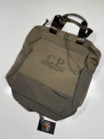 CP Company Chrome-R Tote Backpack in Green 

Rrp £255 

Large and versatile bag from C.P. Company in their nylon based Chrome-R material with tote straps and adjustable padded straps. The tote bag/backpack also features a large zipped main compartment with an inner zip sleeve, zipped front pocket, two side pouches with drawcord closure and a tonal C.P. Company logo embroidered on the front. 

100% Nylon
Water Resistant
Tote Handles
Padded Adjustable Shoulder Straps
Large Main Zip Compartment
Inner Zipped Sleeve
Drawcord Adjustable Side Pouches
Front Zipped Pocket
Certi cut 
Tonal Logo Embroidery To Front
Approx 17” x 18” 

£120 

6 available Copy - Image 6