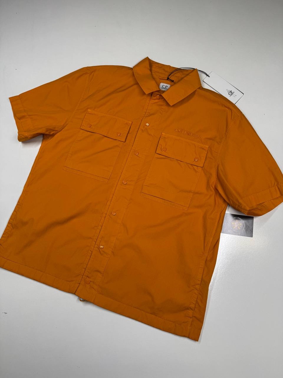 img_3825-2 New Season CP Company Cotton Rip-Stop Short sleeve shirt in Orange - Large / 22” P2P - Image 1