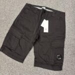 C.P COMPANY 116A SATIN STRETCH CARGO SHORTS IN BLACK