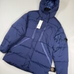 C.P. COMPANY 173A GARMENT DYED 'NYCRA-R”DOWN LENS HOODED JACKET IN BLUEPRINT